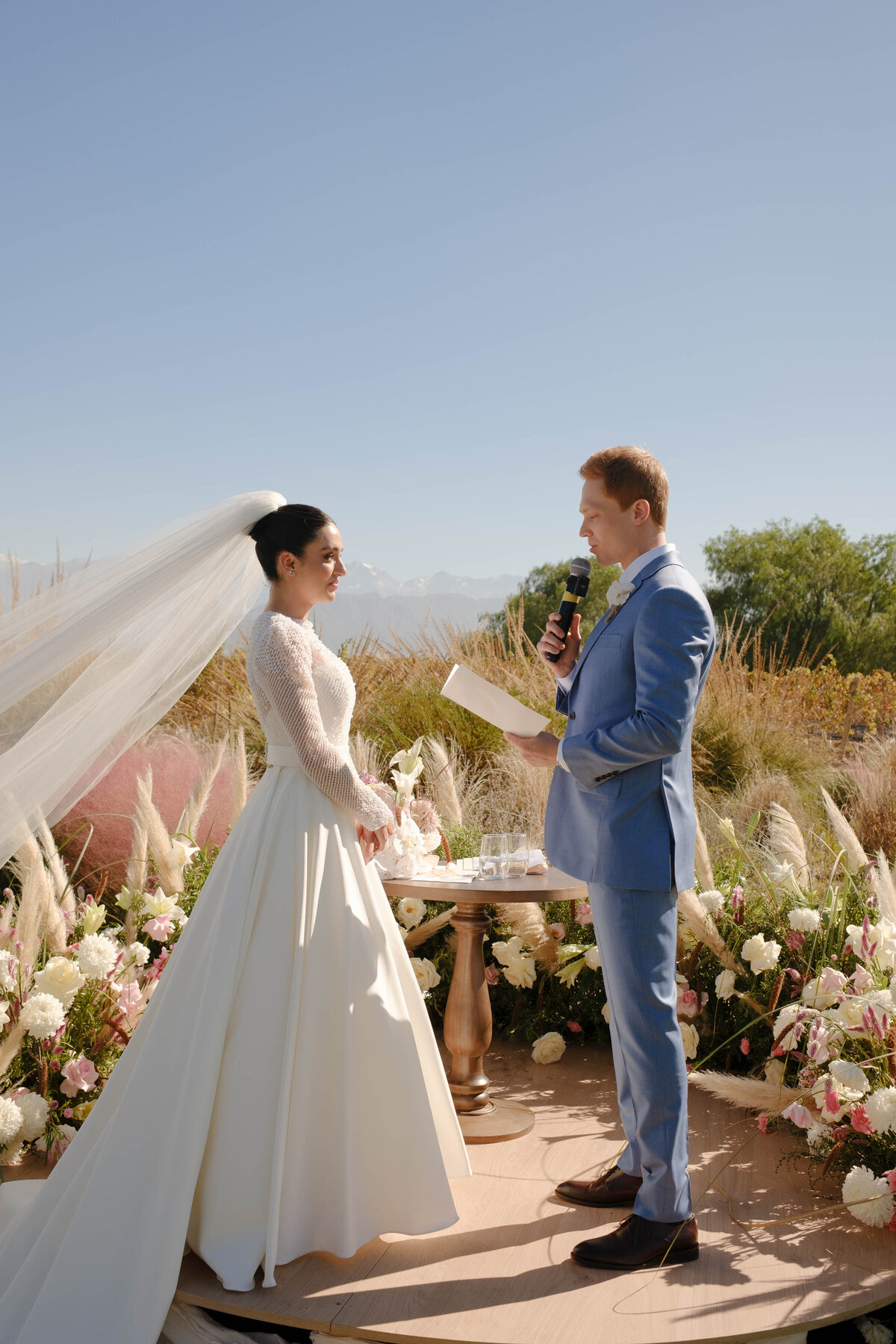 Bride and groom exchanging vows in a vineyard