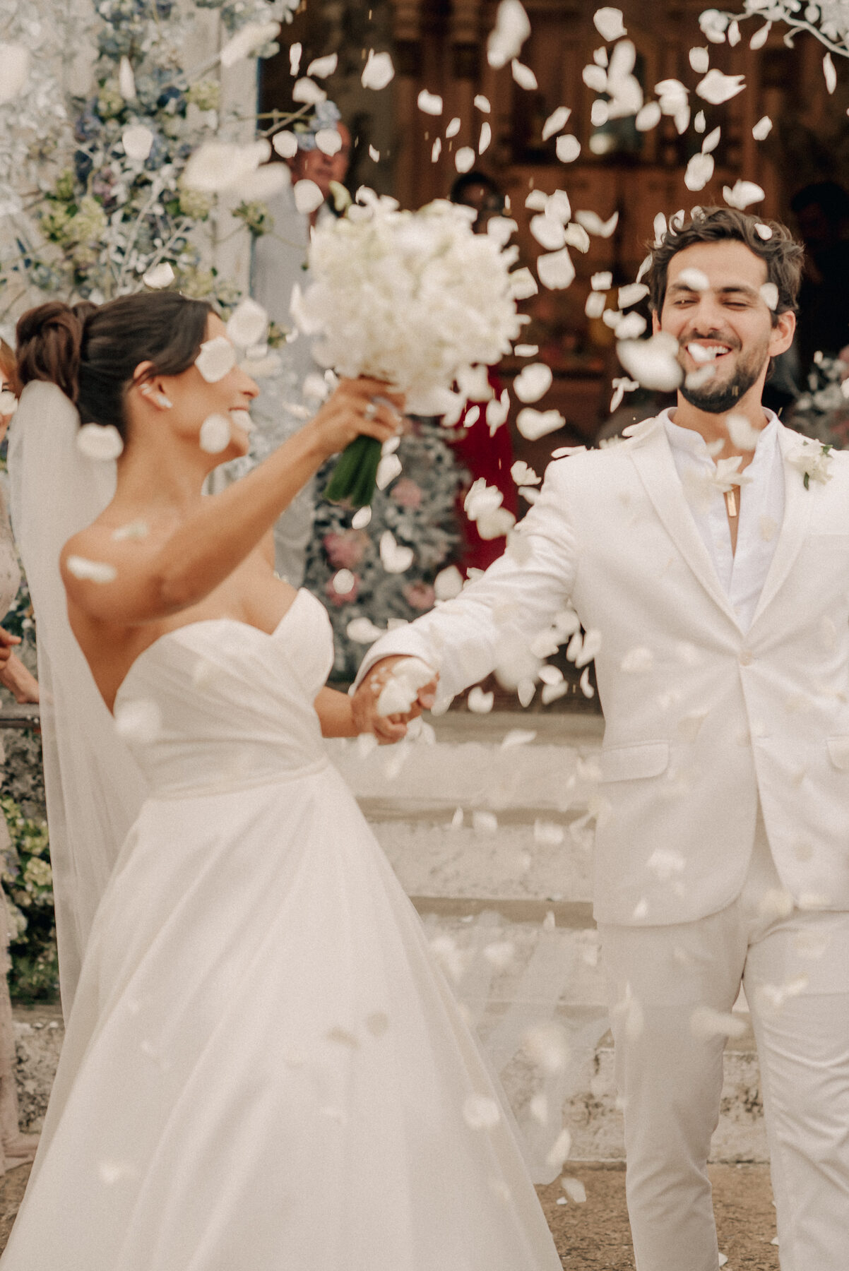Newlyweds celebrating under a shower of petals