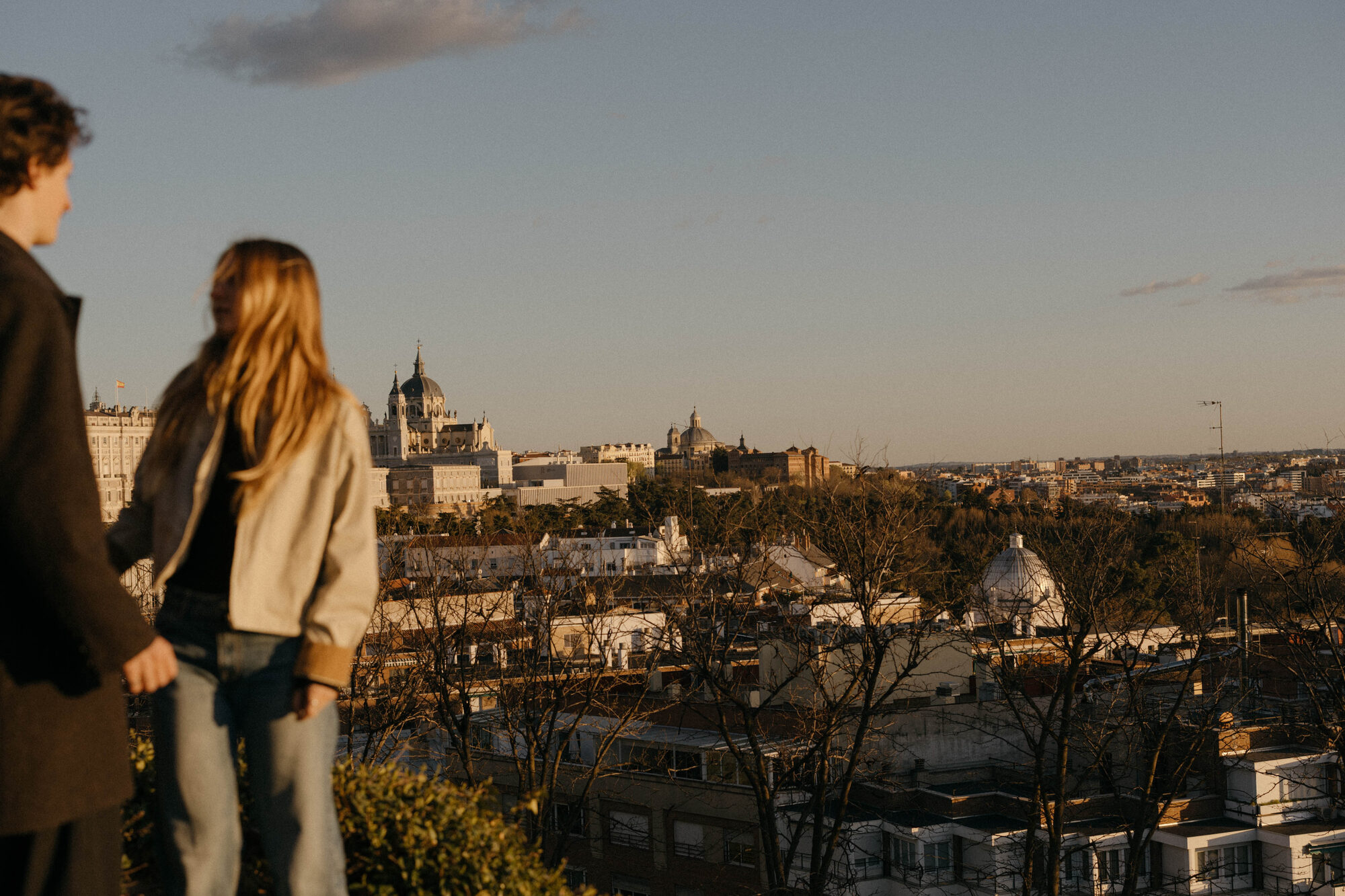Couple overlooking the Madrid skyline at golden hour